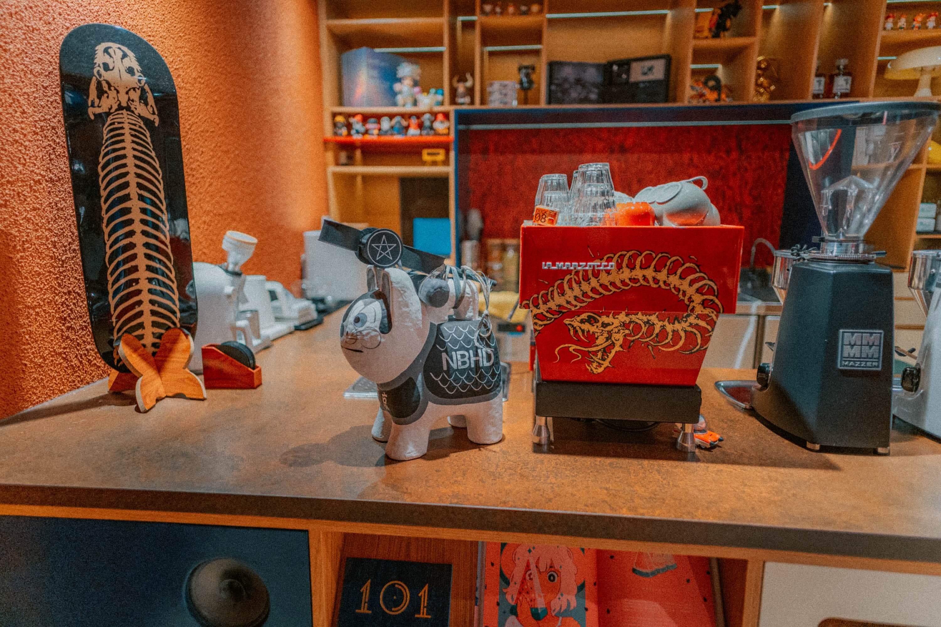 A red espresso machine at the Artisan bar