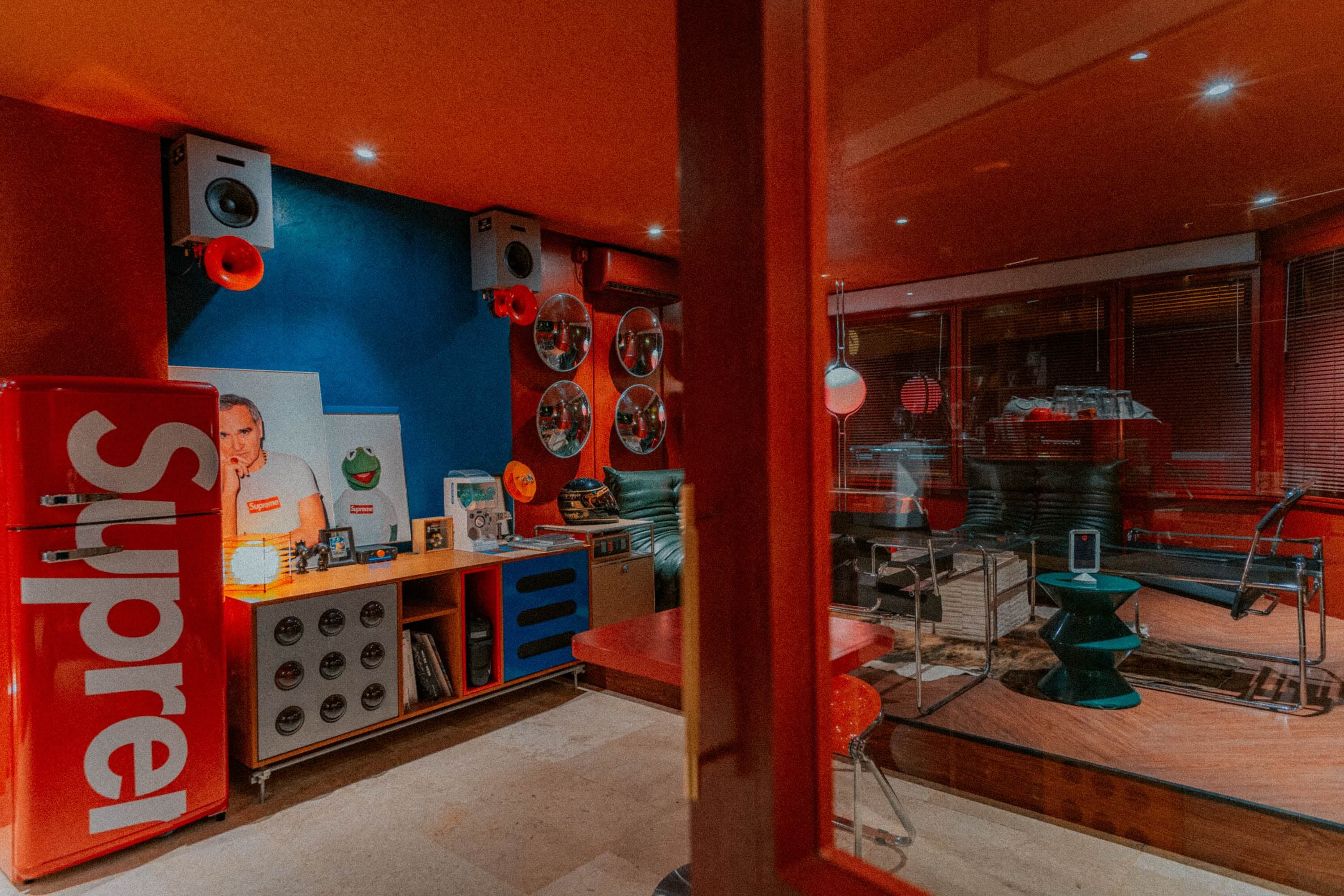 Retro lobby with a red fridge, speakers and convex mirrors