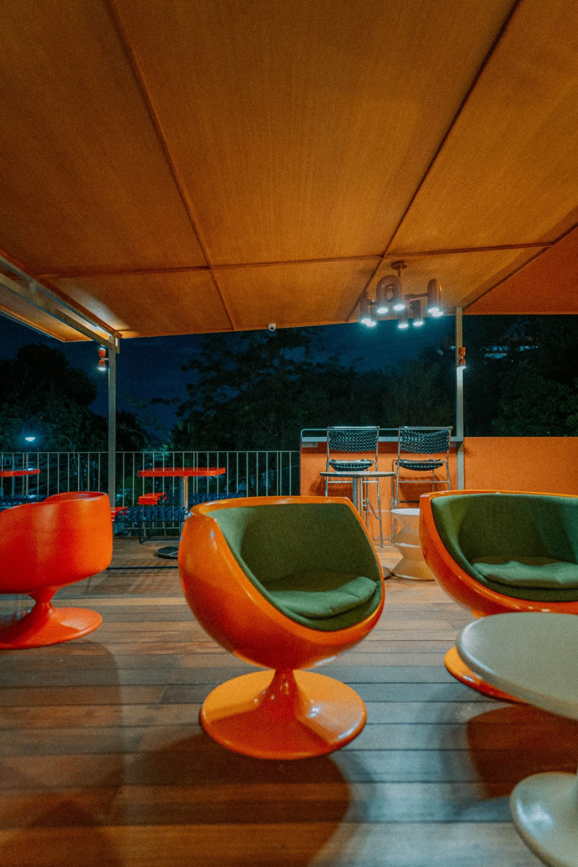 Orange egg chairs on the Artisan terrace